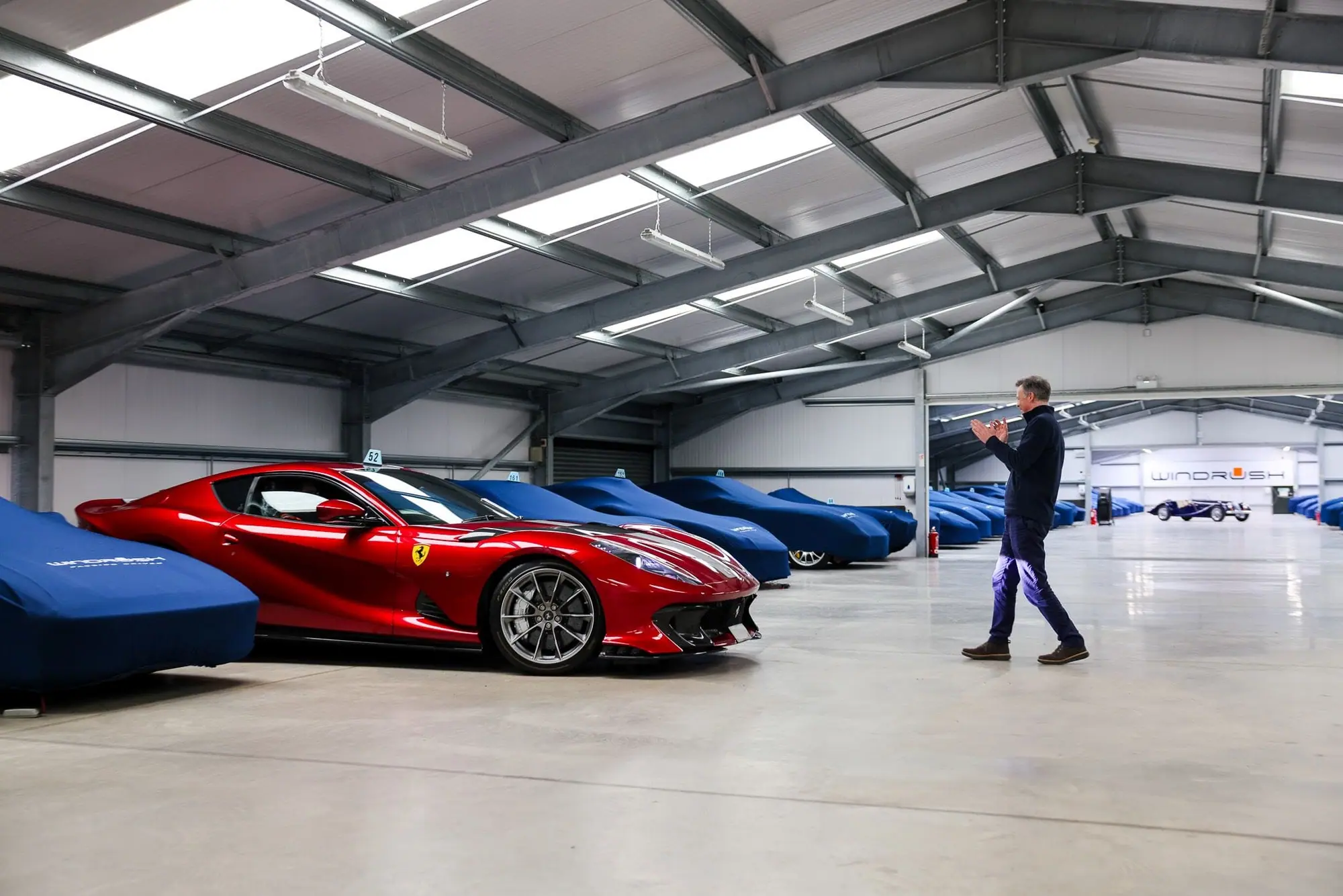 A red Ferrari leaving its bay in the Cotswolds