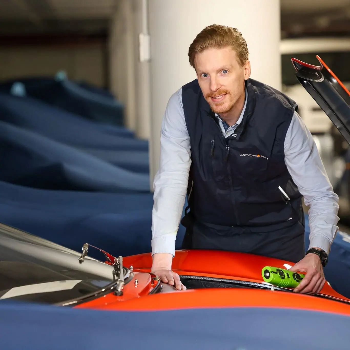 Drawing the navy cover over a car