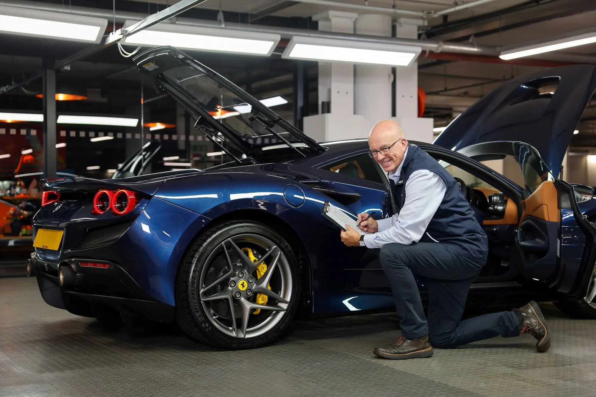 Inspecting a car with the bonnet open