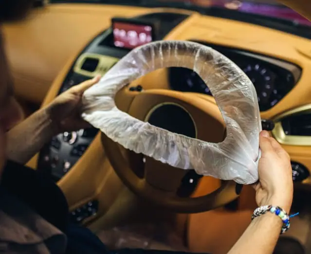 A protective cover fitted over the steering wheel