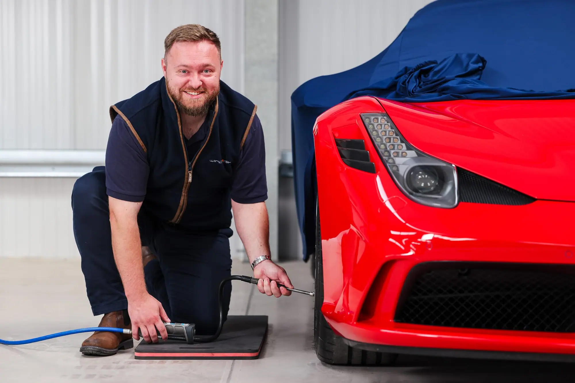 Checking tyre pressures on a Ferrari