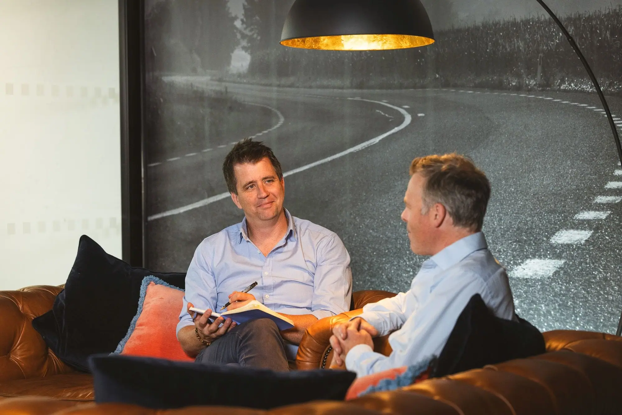 Tim Earnshaw with a client in the lounge