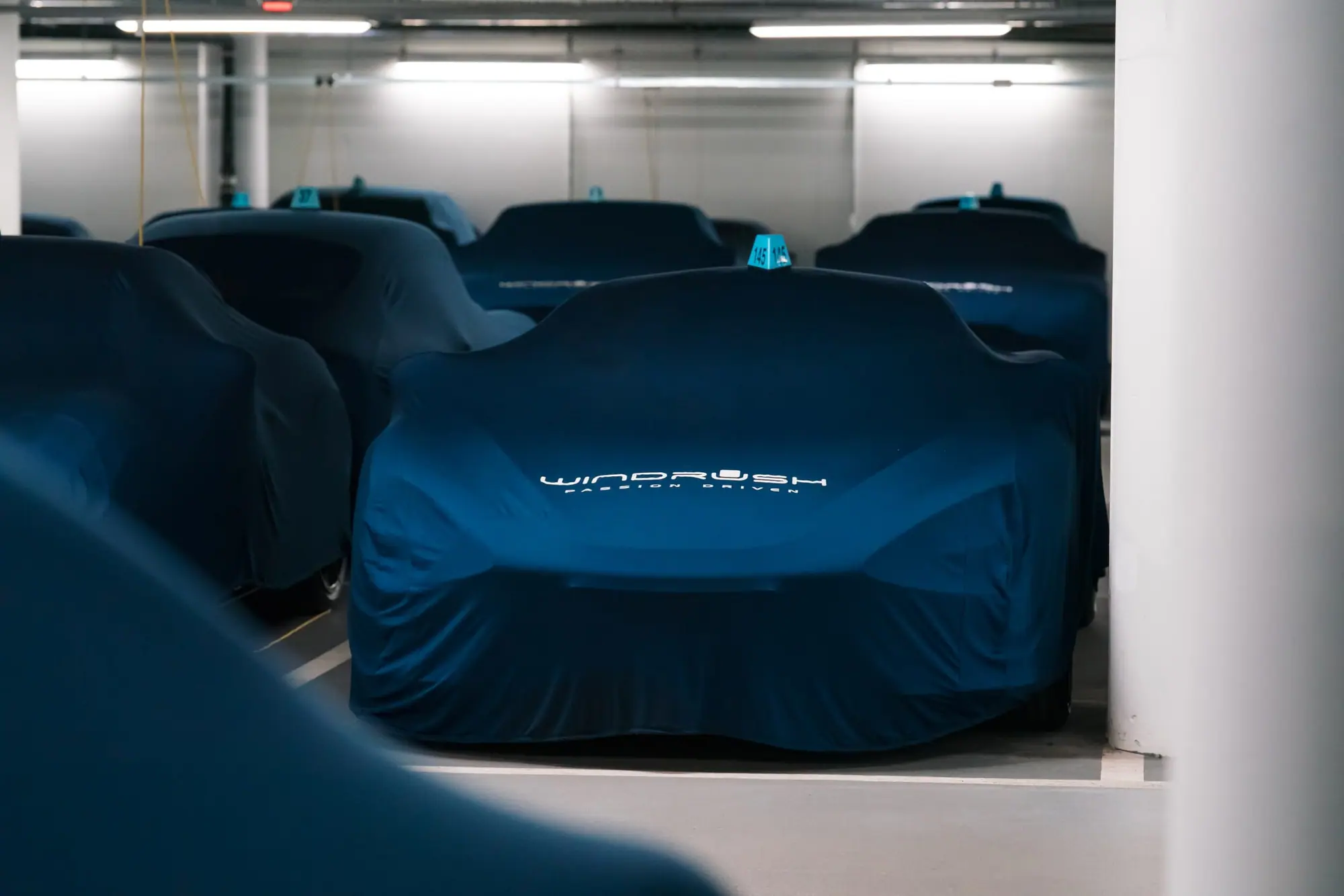 A car resting under its cover