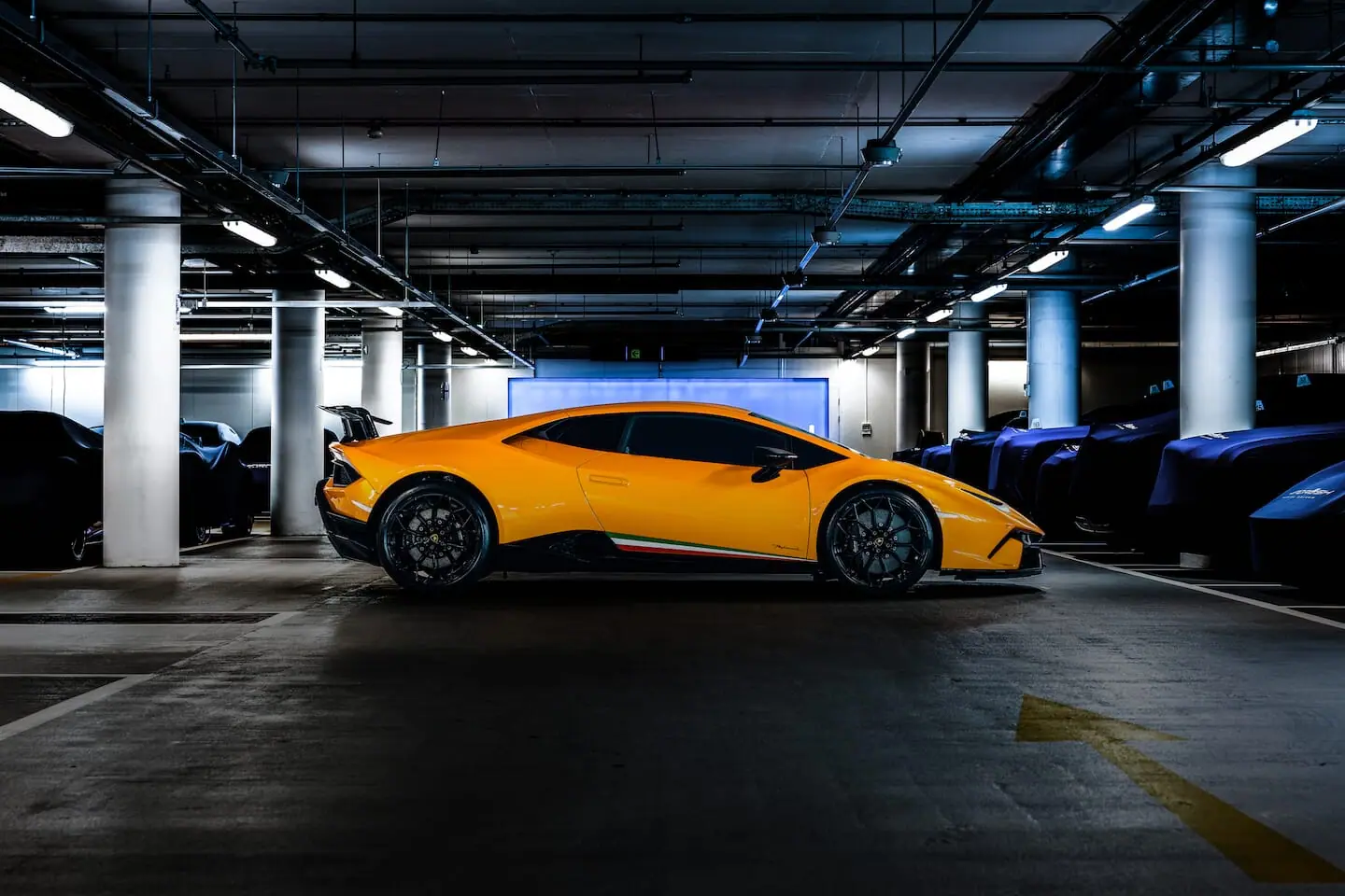 A yellow Lamborghini in a pool of light in the vault