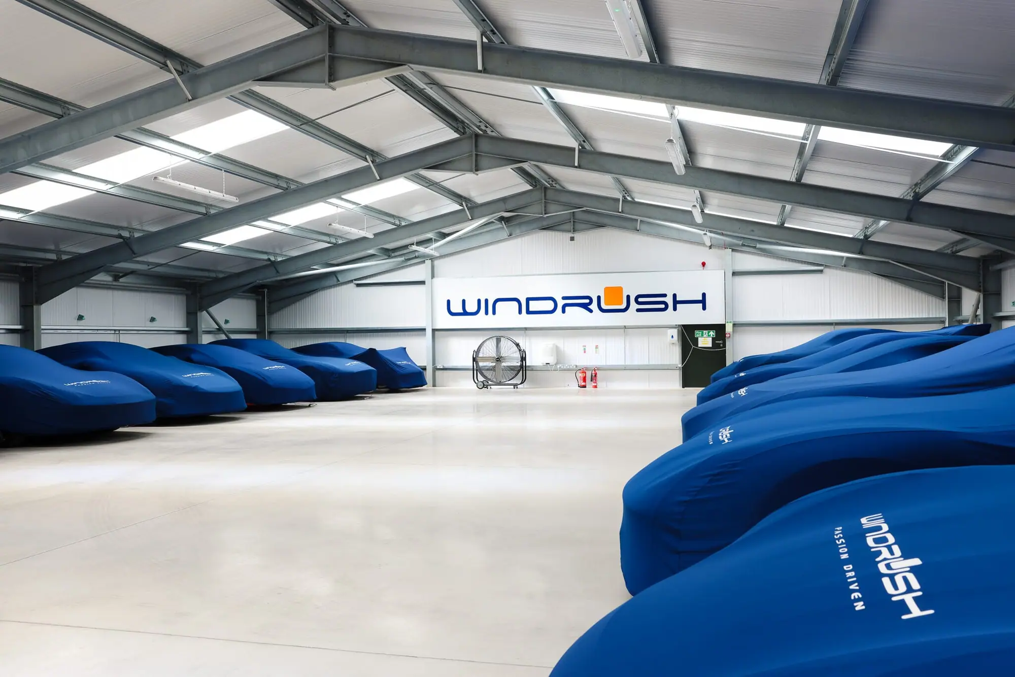 Rows of covered cars in a Cotswolds motor-house