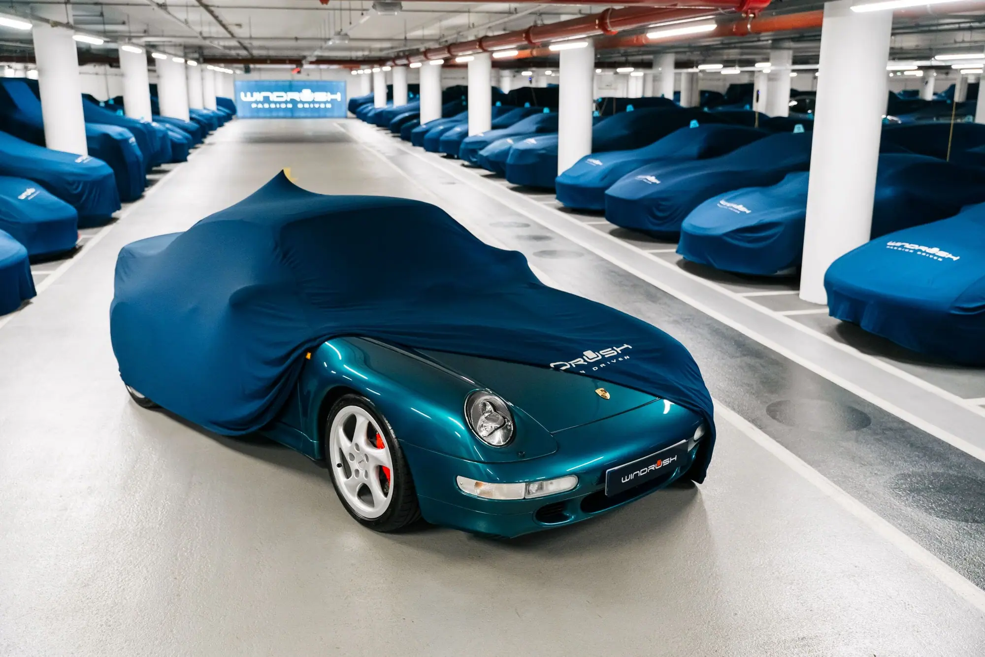 A covered car with its cover drawn back